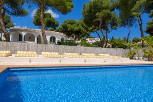 a swimming pool in front of a villa at Quinta la Sal by SingularStays in Jávea