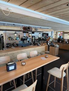 a restaurant with a large wooden table and chairs at Chalet Sepp in Belalp +41 photos