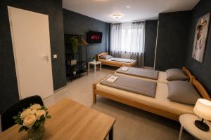 a bedroom with a large bed and a living room at Moderne Appartement in Nuremberg