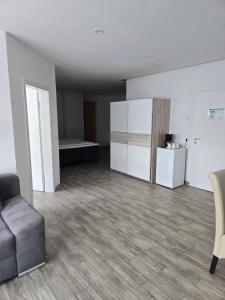 an empty living room with a couch and a refrigerator at Marina Niederhavel in Brandenburg an der Havel +25 photos