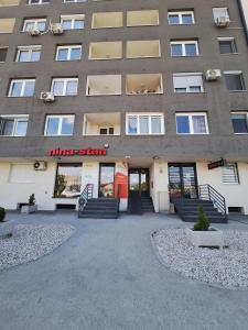 aartment building with a entrance to a building with stairs at Apartment Stup Sarajevo in Sarajevo