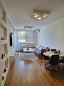 a living room with a couch and a table at Apartment Stup Sarajevo in Sarajevo