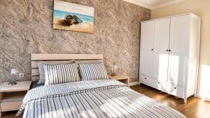 a bedroom with a bed and a white cabinet at Guest House Forest 20 in Balchik +35 photos
