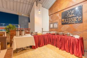a restaurant with two tables with red table skirts at Treebo Golden Sun Inn, 5 Mins To Rock Beach in Pondicherry