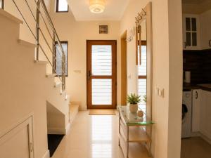 a hallway with a staircase and a door in a house at Guest House Forest 20 in Balchik