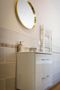a bathroom with a sink and a mirror at La suite Isabelle de Luxembourg in Béthune +12 photos