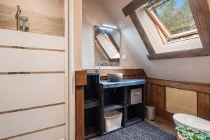 a bathroom with a sink and a skylight at Iaks keramik in Saumont-la-Poterie