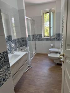 a bathroom with two sinks and two toilets at Almaré Luxury Beach Apartments in Taranto