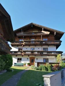 a large building with balconies on the side of it at Ferienhaus Oberhuben in Fügenberg