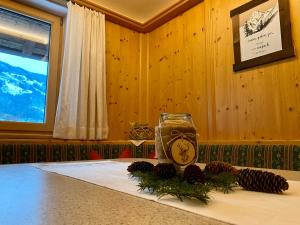 a table with a clock and pine cones on it at Ferienhaus Oberhuben in Fügenberg