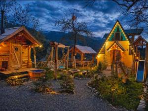a log cabin with a playground in the yard at MOSES HOUSE-მოსეს სახლი in Baladzeyebi