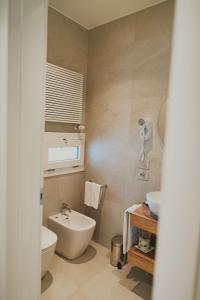a bathroom with a white toilet and a sink at Hotel Magnolia in Preganziol +25 photos