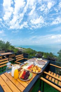 a table with plates of food on top of a balcony at The Olive Garden in Shkodër