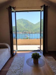 a living room with a door open to a balcony at Apart Capital FISA Kamenari in Kamenari