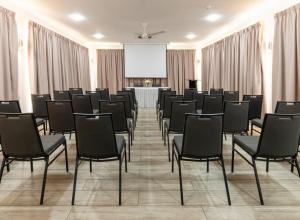 a conference room with chairs and a projection screen at Voilà Beau Vallon in Beau Vallon +25 photos