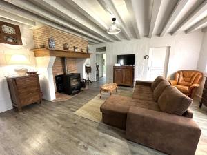 a living room with a couch and a fireplace at Riban in Sabres