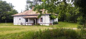 an old white house sitting in a field at Riban in Sabres