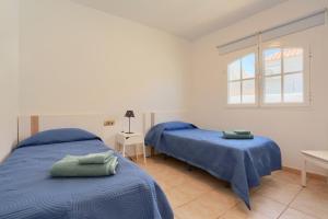 a bedroom with two beds and a window at Refugio del Viento in Antigua +40 photos