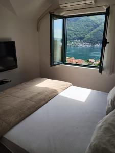 a bed in a room with a large window at Apart Capital FISA Kamenari in Kamenari +35 photos