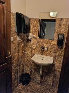 a bathroom with a sink and a mirror at Boutique Hotel Empress in Rožňava +43 photos
