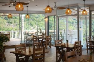 a restaurant with wooden tables and chairs and windows at Ölüdeniz Manzara Non Alcoholic Family Hotel in Oludeniz +107 photos