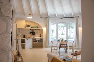 a kitchen and living room with a table and chairs at Quinta la Sal by SingularStays in Jávea