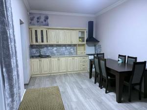 a kitchen and dining room with a table and chairs at Dilisharm in Dilijan