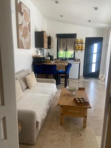 a living room with a couch and a table at Gîte chez l'habitant indépendant "La villa des ocres" in Gargas