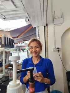 a woman is standing in a food truck at Sun Chakra Boutique Hotel - 50m to Museum & Royal Palace & Walking street in Phnom Penh