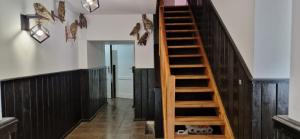a wooden staircase in a room with black walls at Domek- Bożejów in Radomierowice