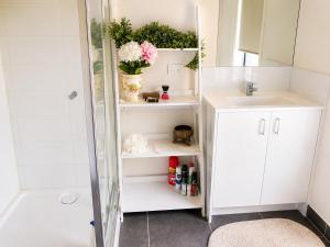 a bathroom with a shower and a sink and a mirror at Room in Officer in Officer