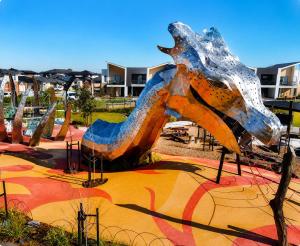 a statue of a dragon in a park at Room in Officer in Officer