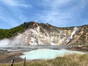 a view of a geyser with steam coming out at ROHAUS Entire Home with private Hot Spring in Shiraoi