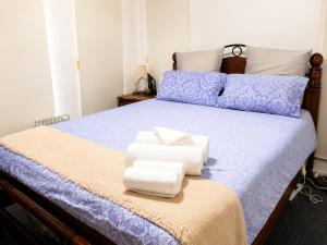 a bedroom with a bed with towels on it at Room in Officer in Officer