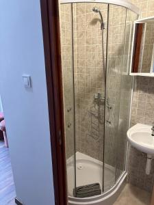 a bathroom with a shower and a sink at Kincső Vendégház Siófok in Siófok