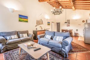 a living room with two couches and a table at Tenuta della Selva - Castellaccio 7 in Murlo
