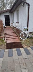 a bike is parked in front of a house at Domek- Bożejów in Radomierowice