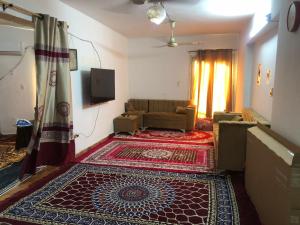 a living room with a couch and a rug at مقاولين العرب in Cairo