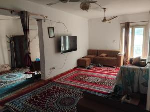 a living room with a couch and a flat screen tv at مقاولين العرب in Cairo +4 photos