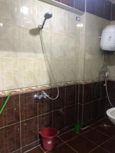 a shower in a bathroom with a red bucket at مقاولين العرب in Cairo