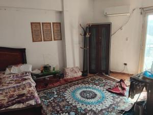 a room with a bed and a rug on the floor at مقاولين العرب in Cairo