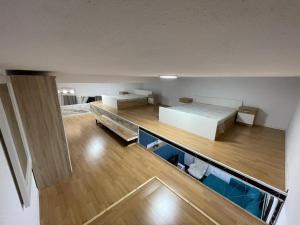 a view of a room with a bed and wooden floors at Dua Apartament in Kashari