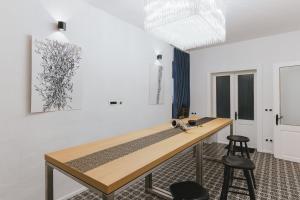 a room with a wooden table and two stools at Sobe Lotrist in Radovljica +38 photos