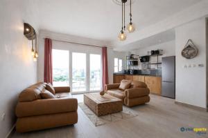a living room with two couches and a table at Chic apart with a view in Yaoundé