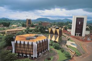 an overhead view of a city with a large building at Chic apart with a view in Yaoundé