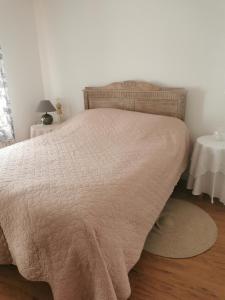 a bedroom with a bed with a blanket on it at La douce Campagne in Flavigny-le-Grand-et-Beaurain