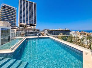 a swimming pool on the roof of a building at A Plus Hotel St Julians - Adults Only in St. Julianʼs