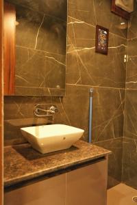 a bathroom with a white sink on a counter at Noor Villa Mohali in Lāndrān +9 photos