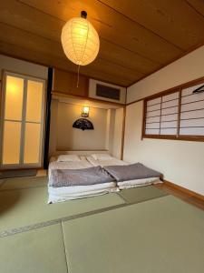 a bedroom with a bed and a chandelier at 雅 in Kyoto
