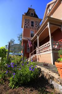 a house with purple flowers in front of it at Cheney House Bed & Breakfast in Ashland